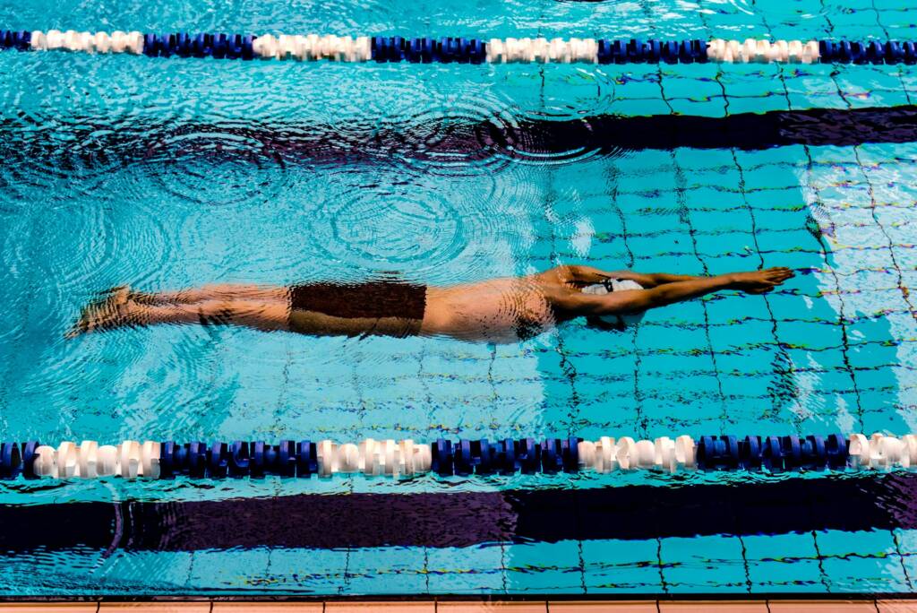 Certified coach guiding an adult in swimming lessons for adults in Dubai at Larsson International Sport Academy.